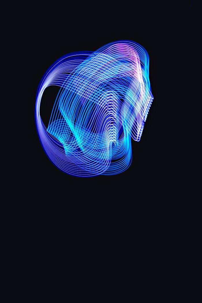 Vibrant abstract blue light trails creating a dynamic pattern against a black backdrop.